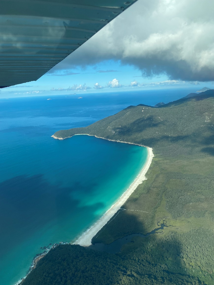 View out of plane window showing clear waters over Wilsons Prom